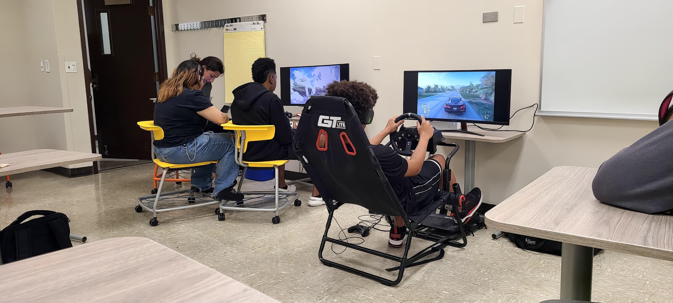 Creative gaming workshop—students collaborating on PCs